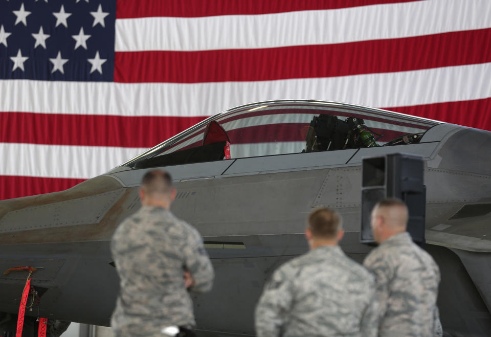 Soldiers stand in front of a U.S. Air Force F-22 Raptor fighter jet during a briefing in a hangar at U.S. Spangdahlem Air Base, Germany, September 3, 2015. REUTERS/Ina Fassbender