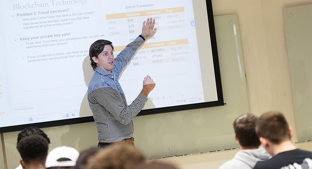 Binghamton University School of Business Assistant Professor Brad Cannon teaches a finance course in September 2023.