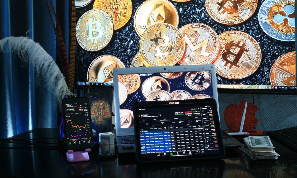 multiple cryptocurrency coins with a trading desk and money and displays showing a day trader making money off the markets.