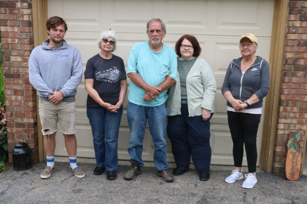 Brenda Campbell, her family and neighbors stand on her driveway in late September.