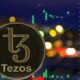 Tezos-XTZ-logo-with-background-of-trading-price-charts