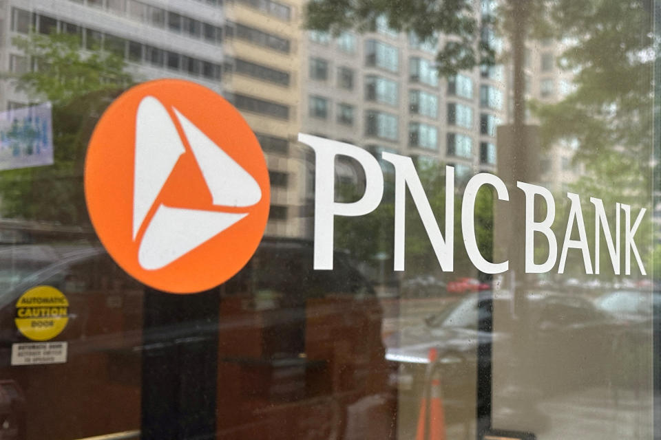 FILE PHOTO: The logo of PNC Bank, a subsidiary of PNC Financial Services Group, is seen on the window of a branch in Washington, U.S., April 30, 2023. REUTERS/Ashraf Fahim/File Photo