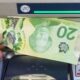 Money is removed from a bank machine in a photo illustration in Montreal, Monday, May 30, 2016. (Ryan Remiorz/The Canadian Press)