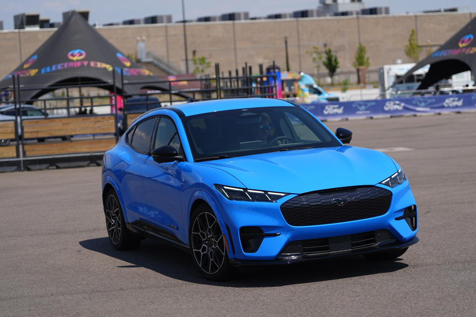 A driver puts a 2024 Ford Mustang Mach-E electric vehicle through its paces on a test track at the Electrify Expo at The Yards, Sunday, July 14, 2024, in north Denver. Ford reports earnings Wednesday, July 24, 2024. (AP Photo/David Zalubowski)