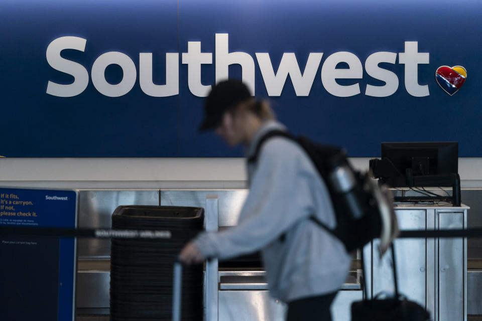 FILE - A traveler walks past a Southwest Airlines ticket counter at Los Angeles International Airport in Los Angeles, April 18, 2023. Federal authorities are investigating a July 14, 2024, incident in which a Southwest jet flew 150 feet (45 meters) over water while still several miles from its intended landing spot at the airport in Tampa, Florida. (AP Photo/Jae C. Hong, File)