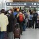 People line up before entering the security zone at Pearson International Airport in Toronto on August 5, 2022.