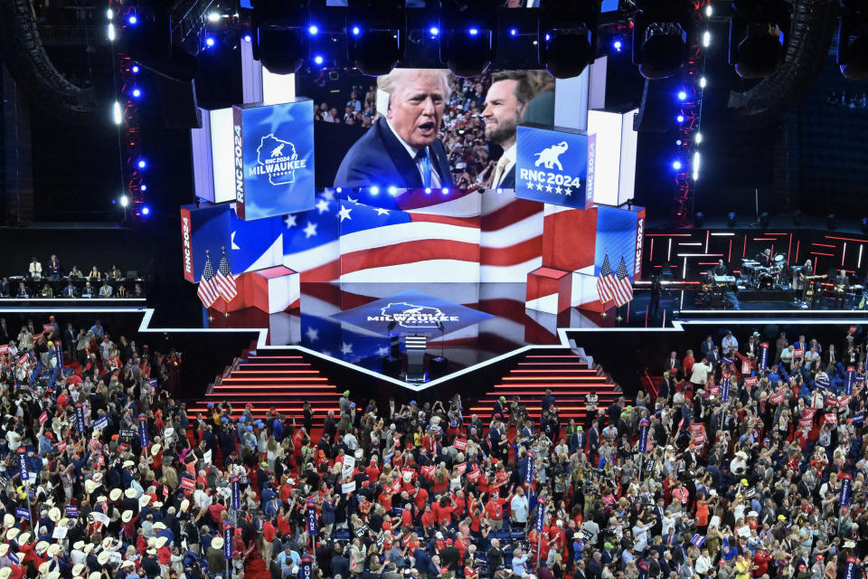 TOPSHOT - Former U.S. President and 2024 Republican presidential candidate Donald Trump is shown on a screen as he arrives during the second day of the 2024 Republican National Convention at the Fiserv Forum in Milwaukee, Wisconsin, on July 16, 2024. Days after surviving an assassination attempt, Donald Trump won the formal nomination as the Republican presidential candidate and chose right-wing loyalist J.D. Vance as his running mate, kicking off a triumphalist party convention after last weekend's failed assassination attempt. (Photo by Pedro UGARTE / AFP) (Photo by PEDRO UGARTE/AFP via Getty Images)